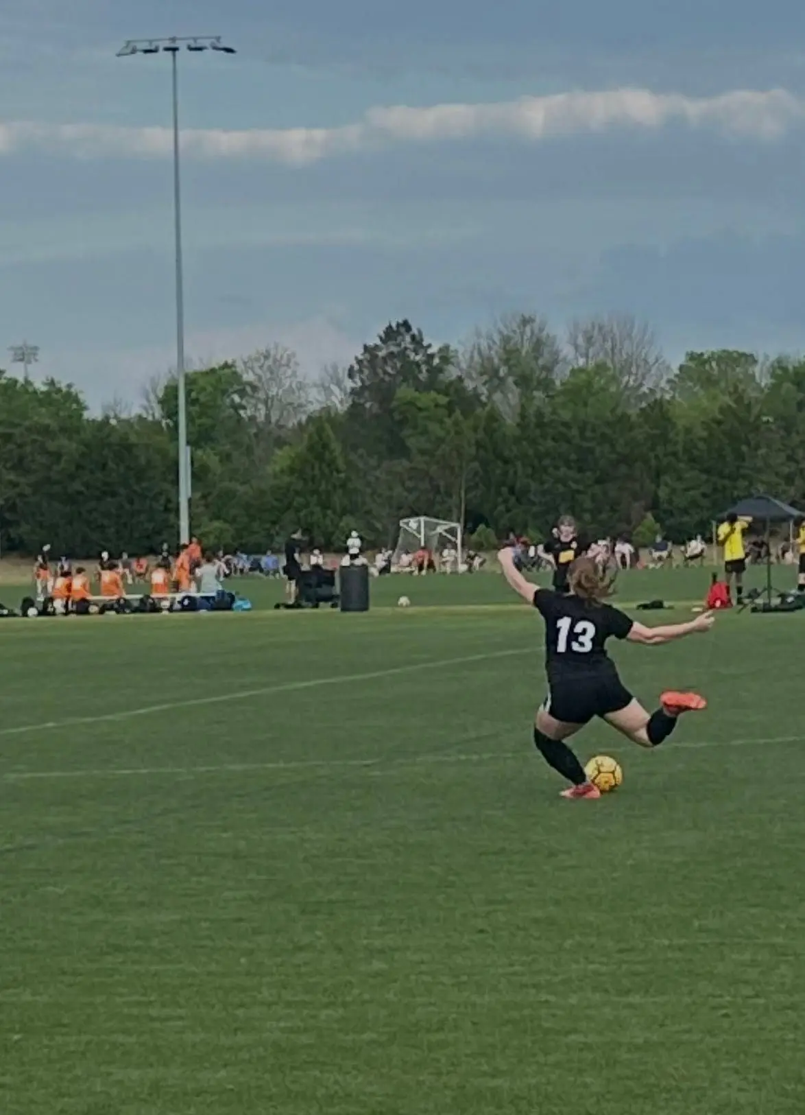 Izabel Barmosz wearing number 13 striking a long pass
